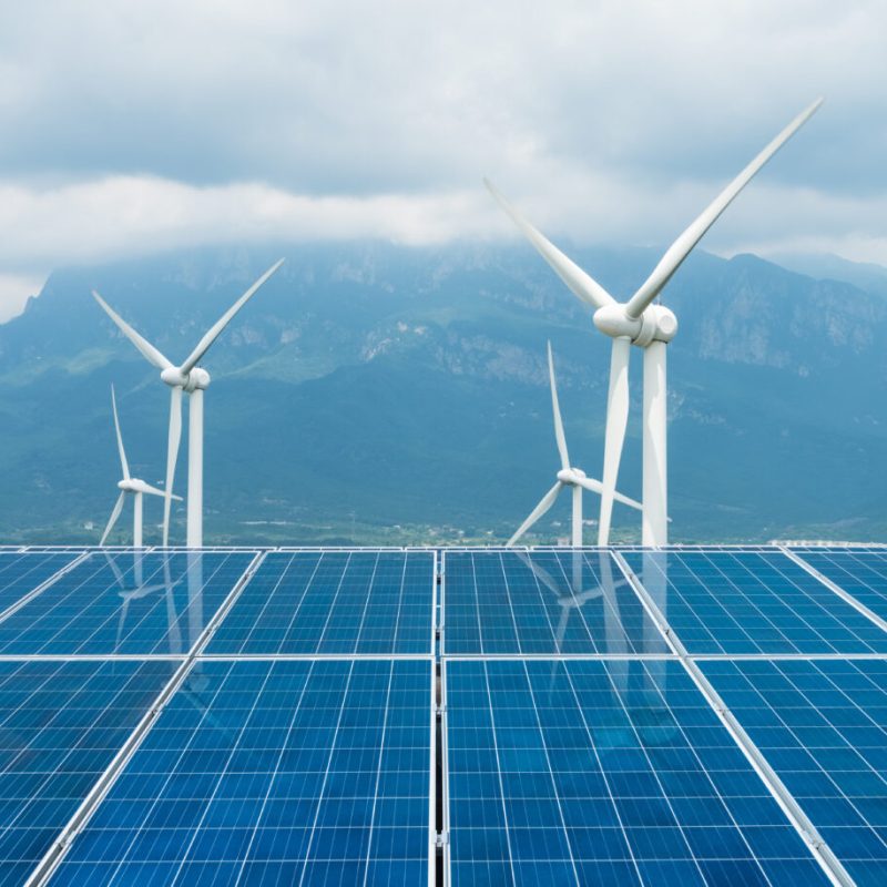 sustainable clean energy, solar panel and wind turbines closeup