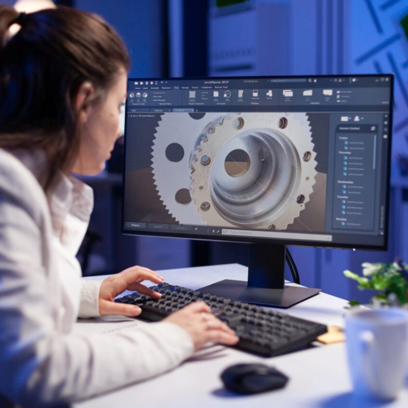 Woman engineer working on new digital prototype using professional construction equipment late at night at office company. Entrepreneur looking at technical architecture before deadline